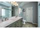 Bathroom featuring a double sink vanity with gray cabinets and light fixtures above a large mirror at 3363 Kinross Ct, Summerville, SC 29485