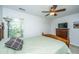Cozy bedroom featuring a ceiling fan, a wooden dresser, and a comfortable bed with a green comforter at 3363 Kinross Ct, Summerville, SC 29485