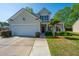 Inviting two-story home with a well-maintained lawn, a two-car garage, and a cozy front porch at 3363 Kinross Ct, Summerville, SC 29485