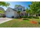 Charming two-story home featuring a manicured lawn, a two-car garage, and inviting curb appeal at 3363 Kinross Ct, Summerville, SC 29485
