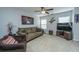 Comfortable living room with carpeted floors, ceiling fan, sofa, and large windows for natural light at 3363 Kinross Ct, Summerville, SC 29485