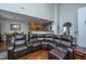 Spacious living room with a leather sectional couch and an open floor plan to the kitchen at 3363 Kinross Ct, Summerville, SC 29485