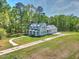 Aerial shot of a beautiful house with a metal roof and mature trees on a large lot at 345 Mentor Rd, Summerville, SC 29483