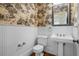 Charming half bathroom featuring vintage wallpaper, white wainscoting, and pedestal sink at 345 Mentor Rd, Summerville, SC 29483