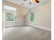 A sunlit bedroom featuring carpet, neutral walls, and views to the outside at 345 Mentor Rd, Summerville, SC 29483