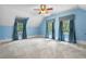 Bright bedroom with sloped ceilings, three large windows, and neutral carpeting at 345 Mentor Rd, Summerville, SC 29483