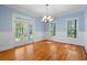 Bright dining room featuring hardwood floors, large windows, and elegant chandelier at 345 Mentor Rd, Summerville, SC 29483