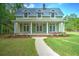 Charming two-story home with a metal roof, inviting front porch, and well-manicured lawn at 345 Mentor Rd, Summerville, SC 29483