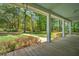Expansive front porch offers a serene view of the lush, tree-lined yard at 345 Mentor Rd, Summerville, SC 29483