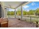 Inviting screened porch with wood floors and serene views of the outdoor landscape at 345 Mentor Rd, Summerville, SC 29483