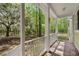 Inviting porch with wooden floors and railing overlooking wooded scenery at 345 Mentor Rd, Summerville, SC 29483