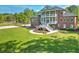 Aerial view showcases a brick home with lush lawn, basketball hoop, and mature trees at 349 Mentor Rd, Summerville, SC 29483