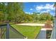 A spacious backyard features a basketball court, lush green grass, mature trees, and a concrete patio at 349 Mentor Rd, Summerville, SC 29483