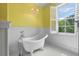 Bathroom featuring a clawfoot tub, beadboard paneling and a window overlooking a wooded view at 349 Mentor Rd, Summerville, SC 29483