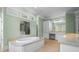 Spacious bathroom with a soaking tub, double vanities, and neutral colored walls at 349 Mentor Rd, Summerville, SC 29483