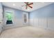 Cozy bedroom with two large windows, neutral carpet, and classic wainscoting at 349 Mentor Rd, Summerville, SC 29483