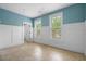 Bright bedroom featuring a tile floor, wainscoting, and two large windows offering natural light at 349 Mentor Rd, Summerville, SC 29483