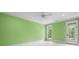 Green bedroom with a ceiling fan, bright natural light, white trim, and access to the porch at 349 Mentor Rd, Summerville, SC 29483