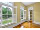 Bedroom featuring two large windows with plantation shutters, yellow walls, and hardwood floors at 349 Mentor Rd, Summerville, SC 29483