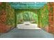 Lush garden path covered in climbing ivy on a brick archway leading to a green landscape at 349 Mentor Rd, Summerville, SC 29483