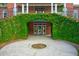 Unique entrance with greenery-covered archway leading to the front door and upper balcony at 349 Mentor Rd, Summerville, SC 29483