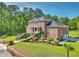 Beautiful brick home boasts meticulous landscaping, a winding staircase, and a charming front porch at 349 Mentor Rd, Summerville, SC 29483