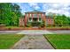 Charming brick home with lush greenery, symmetrical design, and manicured front yard at 349 Mentor Rd, Summerville, SC 29483