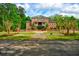 Stunning two-story brick home featuring a symmetrical design, covered porch, and beautiful landscaping at 349 Mentor Rd, Summerville, SC 29483