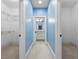 Hallway view featuring blue walls, white trim, and access to a closet and bathroom at 349 Mentor Rd, Summerville, SC 29483