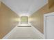 Long, narrow hallway with neutral walls and carpet, leading to a bright window at 349 Mentor Rd, Summerville, SC 29483