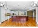 Open kitchen with a large island, hardwood floors, granite countertops and white cabinets, perfect for entertaining and Gathering gatherings at 349 Mentor Rd, Summerville, SC 29483