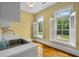 Bright laundry room features a sink with stainless faucet, ample counter space, and windows with plantation shutters at 349 Mentor Rd, Summerville, SC 29483