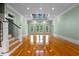 Spacious living room with beautiful hardwood floors, stylish staircase, and large windows at 349 Mentor Rd, Summerville, SC 29483