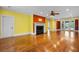 Spacious living room with hardwood floors, a fireplace, and views of the backyard at 349 Mentor Rd, Summerville, SC 29483