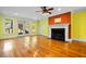 Bright living room with hardwood floors, fireplace, and access to the deck through glass doors at 349 Mentor Rd, Summerville, SC 29483