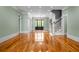 Expansive living room featuring hardwood floors, elegant chandelier, and classic architectural details at 349 Mentor Rd, Summerville, SC 29483