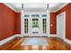 Elegant living room featuring hardwood floors, white French doors, and transom windows at 349 Mentor Rd, Summerville, SC 29483