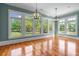 Bright sun room with large windows offering scenic views, complemented by sleek hardwood flooring at 349 Mentor Rd, Summerville, SC 29483