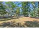 Spacious backyard showcases a charming home nestled among mature trees, creating a private and inviting outdoor space at 3683 Hilton Dr, Johns Island, SC 29455
