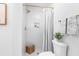 Modern bathroom with a herringbone tile shower, gold fixtures and a plant for added freshness at 3683 Hilton Dr, Johns Island, SC 29455