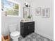Bathroom featuring modern vanity, black hardware, and geometrically patterned tile flooring at 3683 Hilton Dr, Johns Island, SC 29455