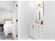 Bright bathroom with a white vanity, gold fixtures and a glimpse into the neutral-toned bedroom at 3683 Hilton Dr, Johns Island, SC 29455