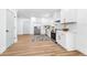 Well-lit kitchen boasts white cabinetry, stainless appliances, and a stylish rug at 3683 Hilton Dr, Johns Island, SC 29455