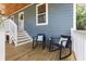 Inviting porch with wooden flooring, white railings, and chairs for relaxing and enjoying the outdoors at 3683 Hilton Dr, Johns Island, SC 29455
