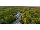 A dense view of housing nestled in the trees with well maintained lawns, a street and neighboring houses at 3718 Sandy Gate Ln, Mount Pleasant, SC 29466
