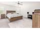 Light and airy bedroom features a wooden bed frame, ceiling fan and light gray walls at 3718 Sandy Gate Ln, Mount Pleasant, SC 29466
