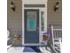 A welcoming front door with a pineapple decoration, plants, and rocking chairs on the porch at 3718 Sandy Gate Ln, Mount Pleasant, SC 29466
