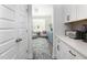 Hallway with white cabinets and countertops leading to the living room at 3718 Sandy Gate Ln, Mount Pleasant, SC 29466