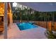 Tranquil pool area with an illuminated waterfall feature, perfect for evening swims and relaxation at 3718 Sandy Gate Ln, Mount Pleasant, SC 29466