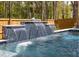 Close-up of a pool waterfall feature with blue tile and a whimsical fish sculpture, creating a tranquil ambiance at 3718 Sandy Gate Ln, Mount Pleasant, SC 29466